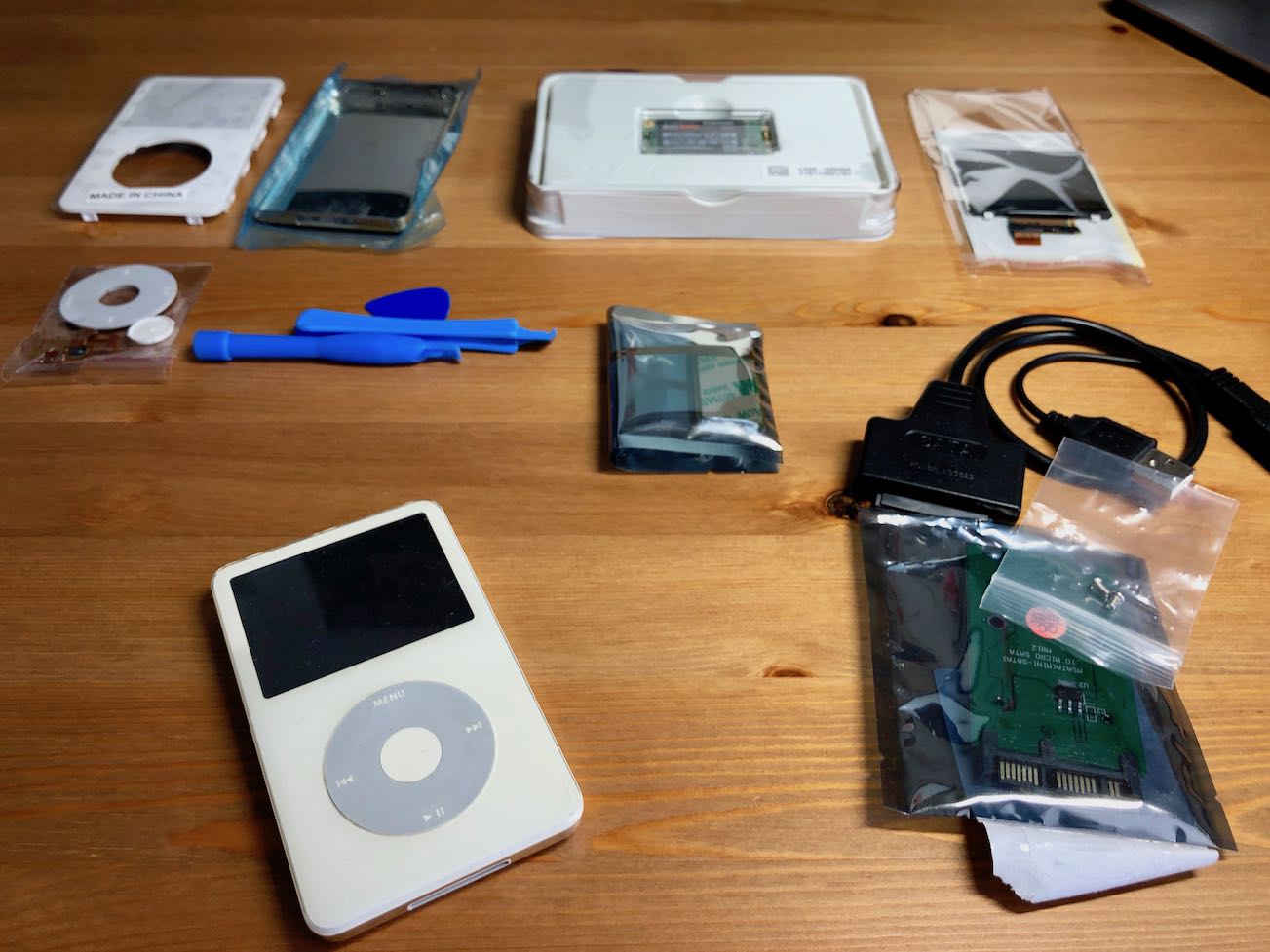 My old iPod Video beside the various replacement components